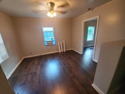 A room with a ceiling fan and a window.