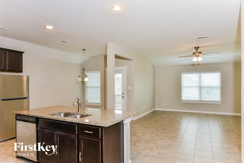A kitchen with a sink and a refrigerator.