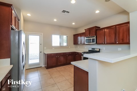 A kitchen with brown cabinets and a white countertop.