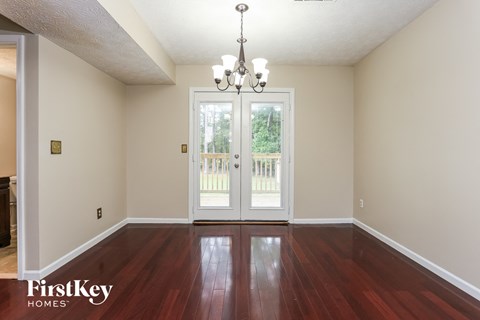 the living room after renovation with hardwood flooring and doors