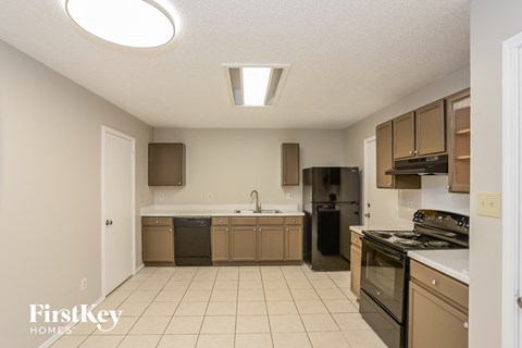 a kitchen with a stove top oven and a sink