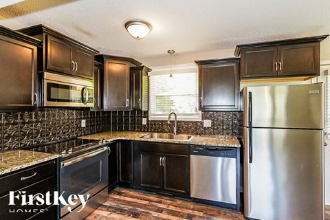 a kitchen with stainless steel appliances and black cabinets