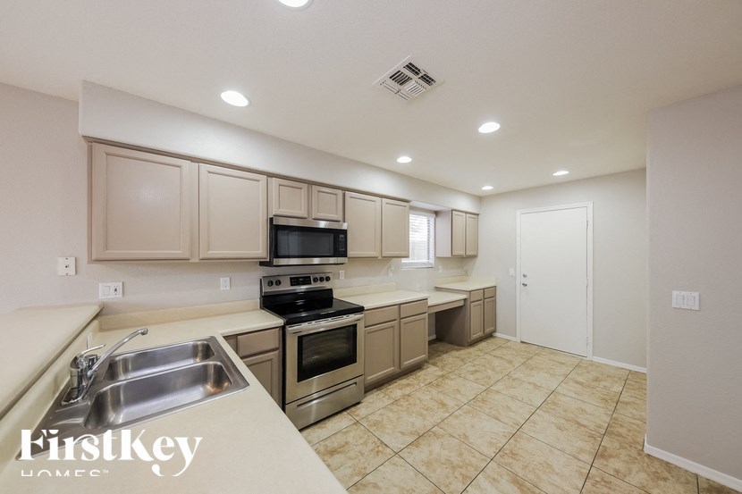 A kitchen with a stove, oven, and sink.