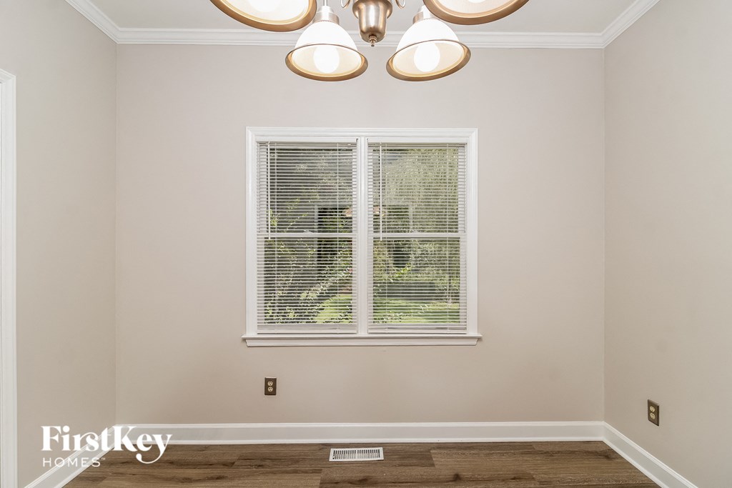 a living room with a window and a chandelier