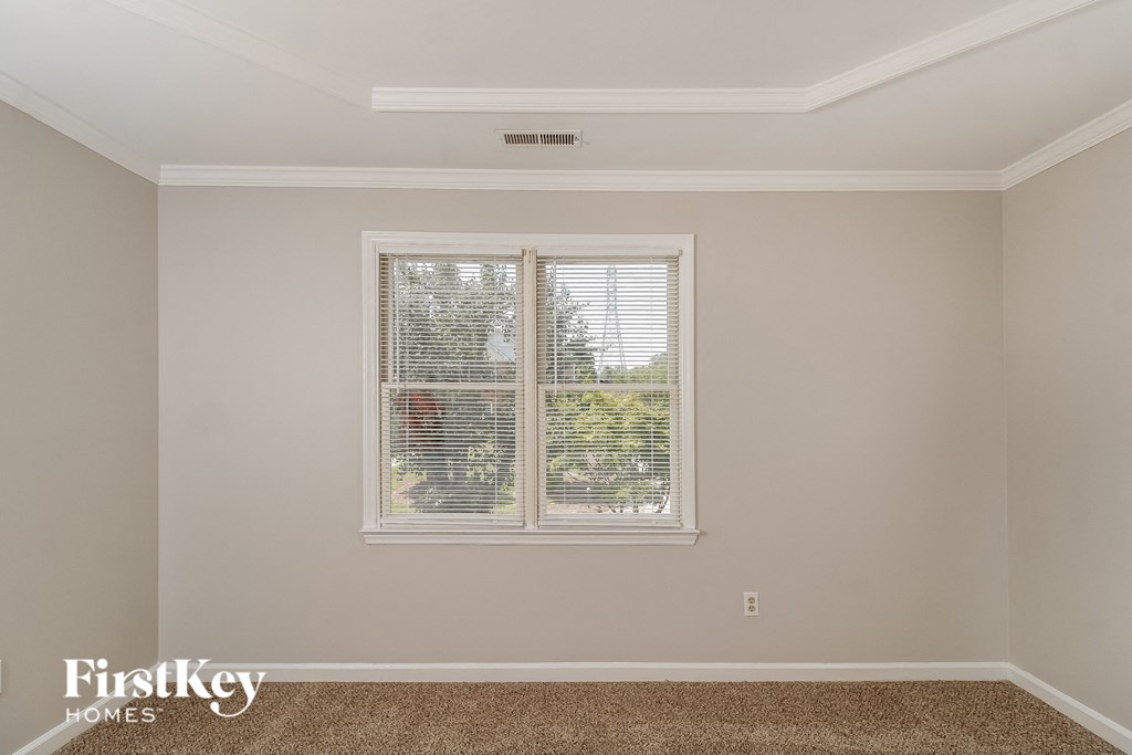a living room with a window with blinds on it