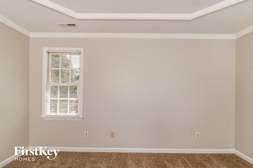 a empty room with white walls and a window