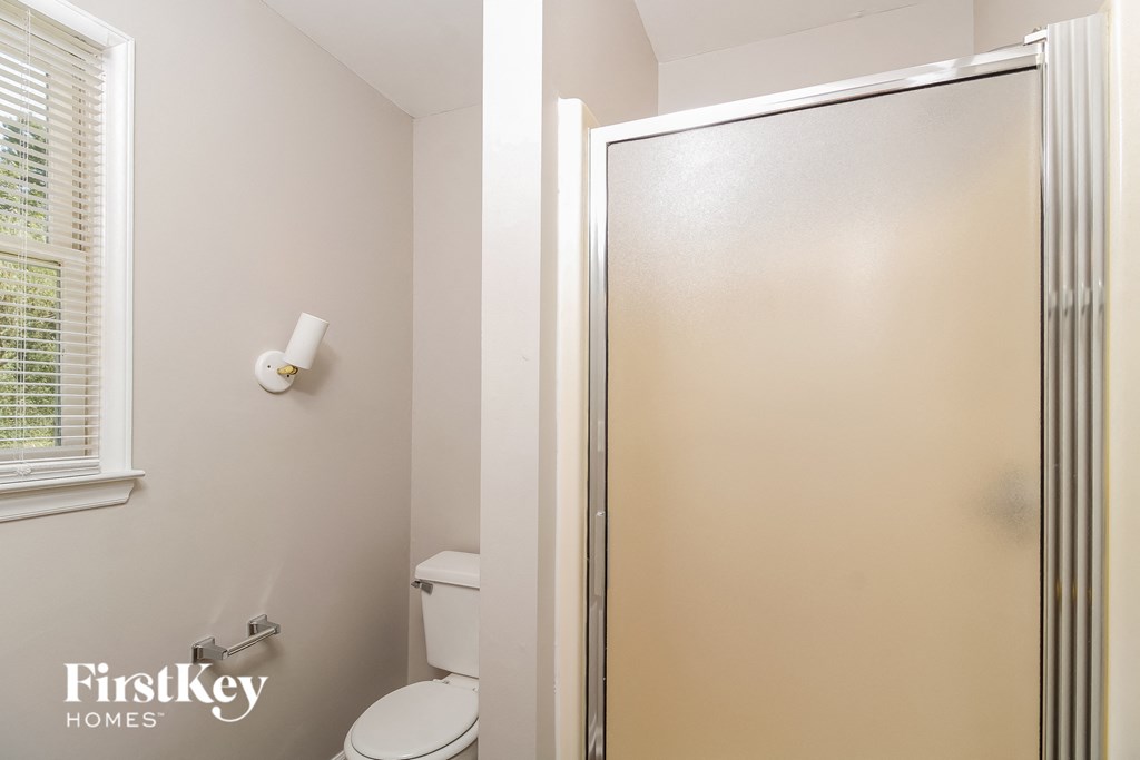 a small bathroom with a shower and a toilet