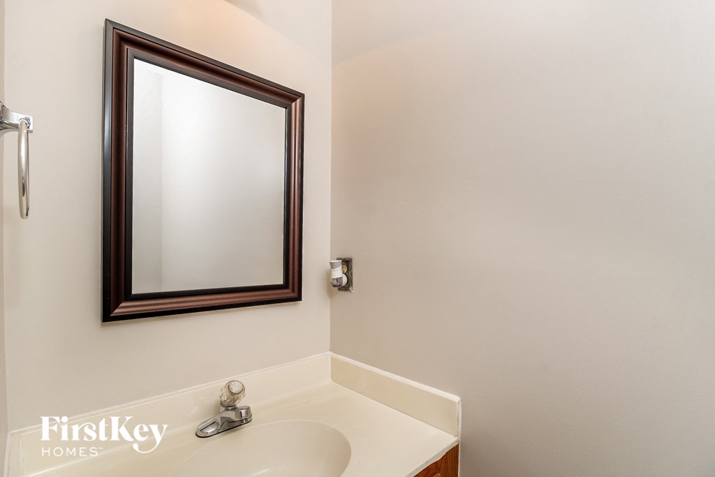 a bathroom with a white sink and a mirror