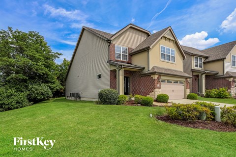 a large house with a lawn and a driveway