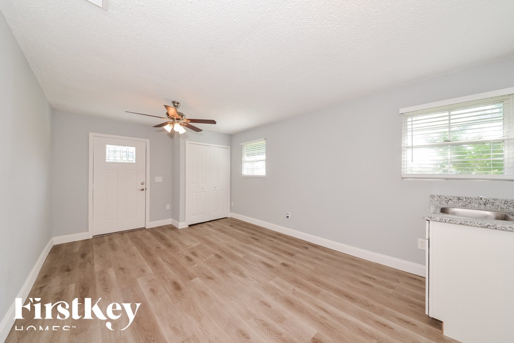 a kitchen and dining room with wood flooring and a ceiling fan