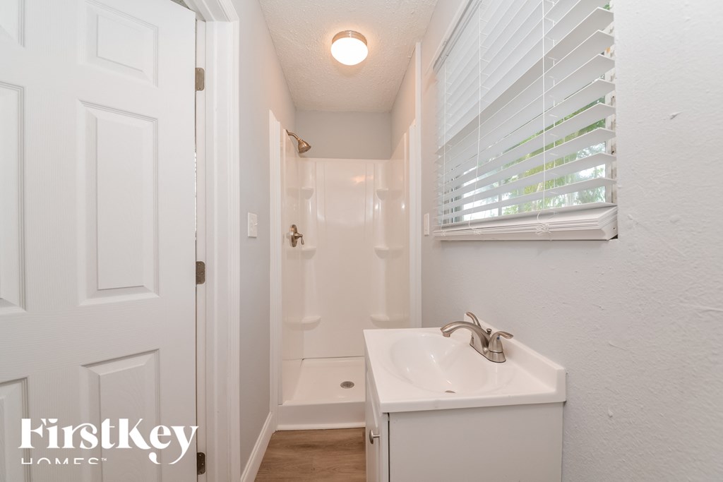 a small bathroom with a sink and a shower