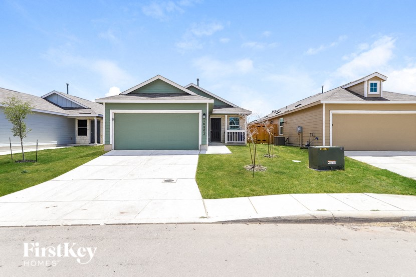 a home with a driveway and a green garage door