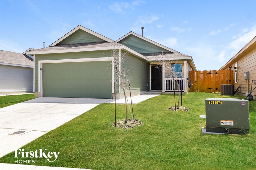 a home with a lawn and a mailbox in front of it