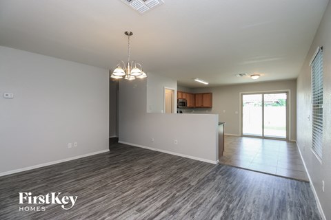 the living room and kitchen of an empty house