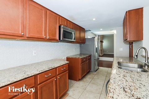 a kitchen with granite counter tops and wooden cabinets