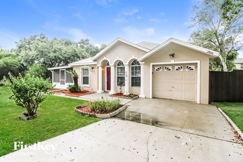a white house with a driveway and a garage door