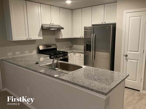 a kitchen with a counter top and a refrigerator
