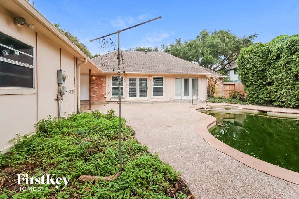 a backyard with a pond and a house