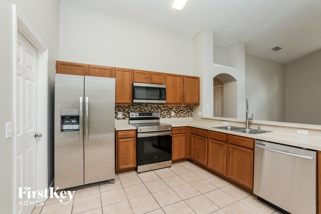 a kitchen with stainless steel appliances and wooden cabinets