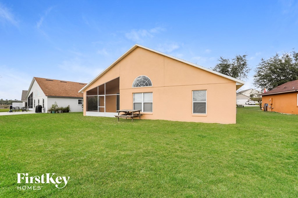 a house with a grass yard and a picnic table