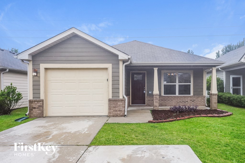 a home with a white garage door and a lawn