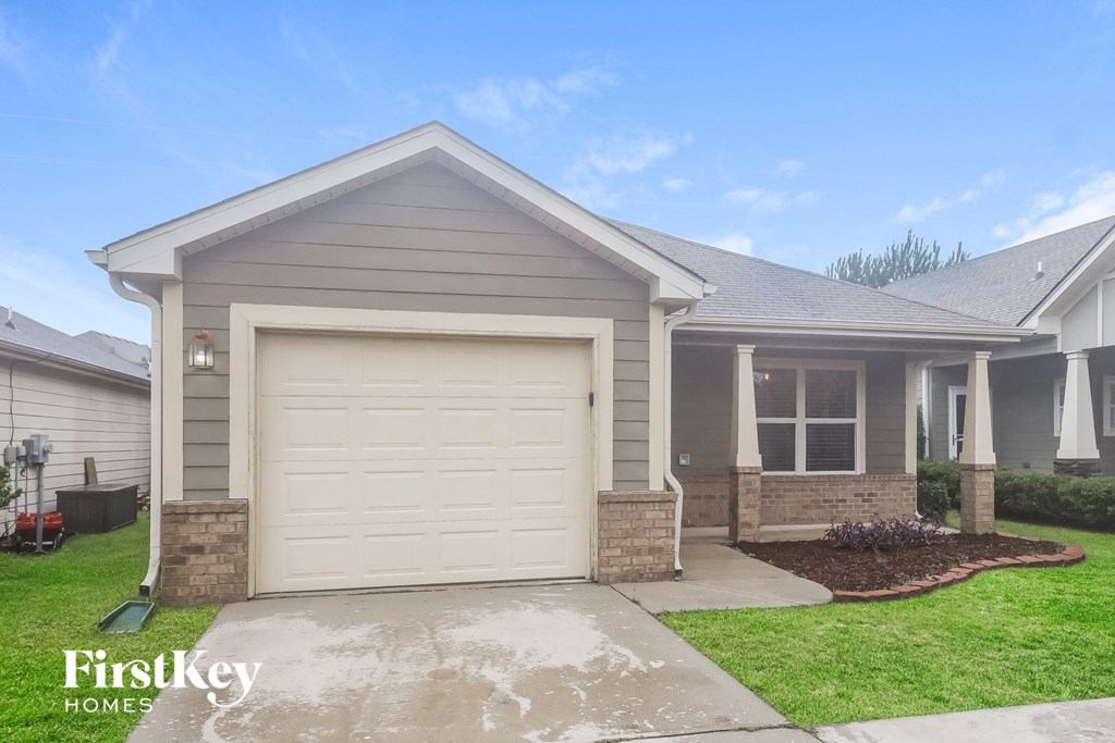 a home with a white garage door in front of it