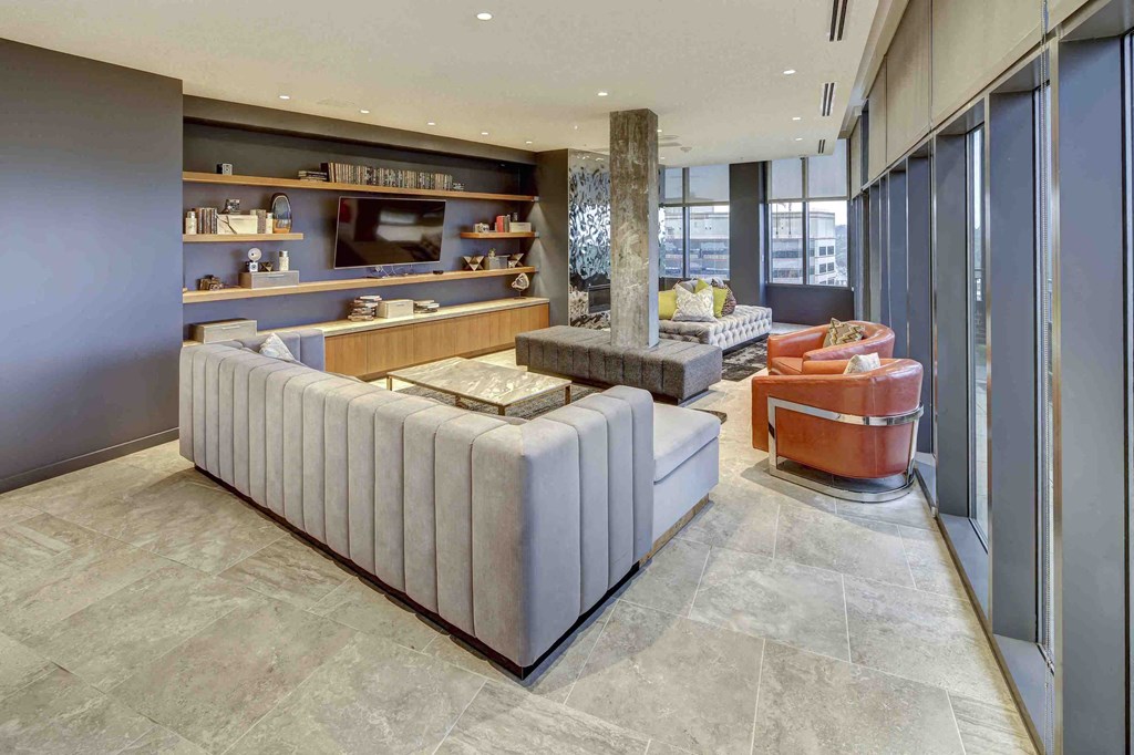 a living room with couches and chairs and a tv