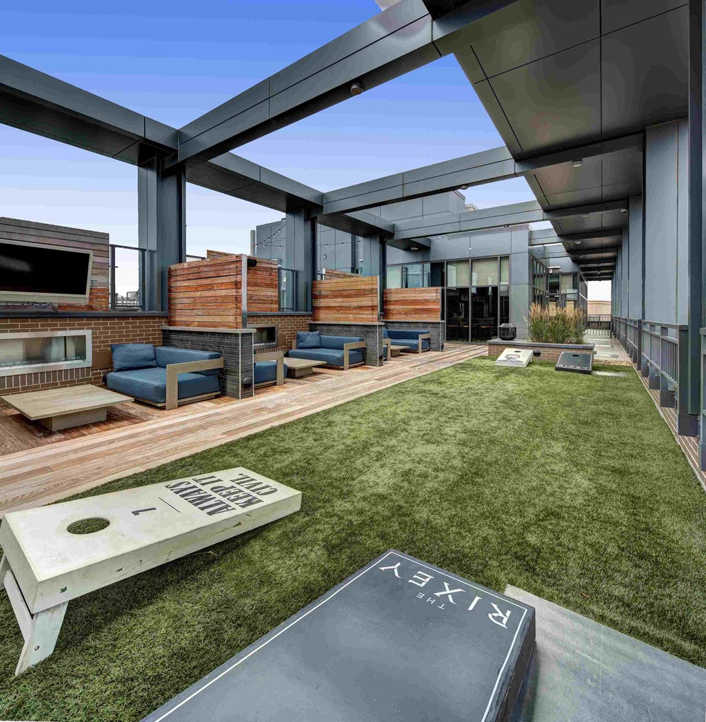 a view of the outdoor living area of a modern house with a lawn