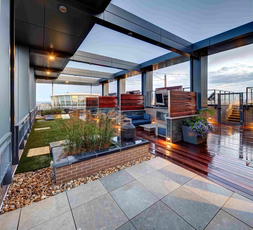 a terrace with a garden and a kitchen on a roof