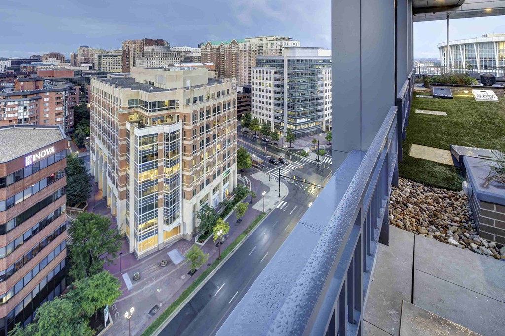 a view of the city from a balcony of an apartment building