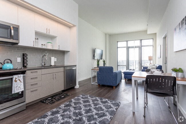 a living room with a kitchen and a dining room