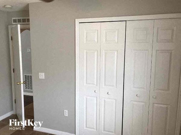 A white door is on the left and two white doors are on the right.