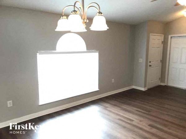 A room with a large window and a chandelier.