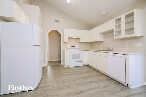 a white kitchen with white appliances and white cabinets