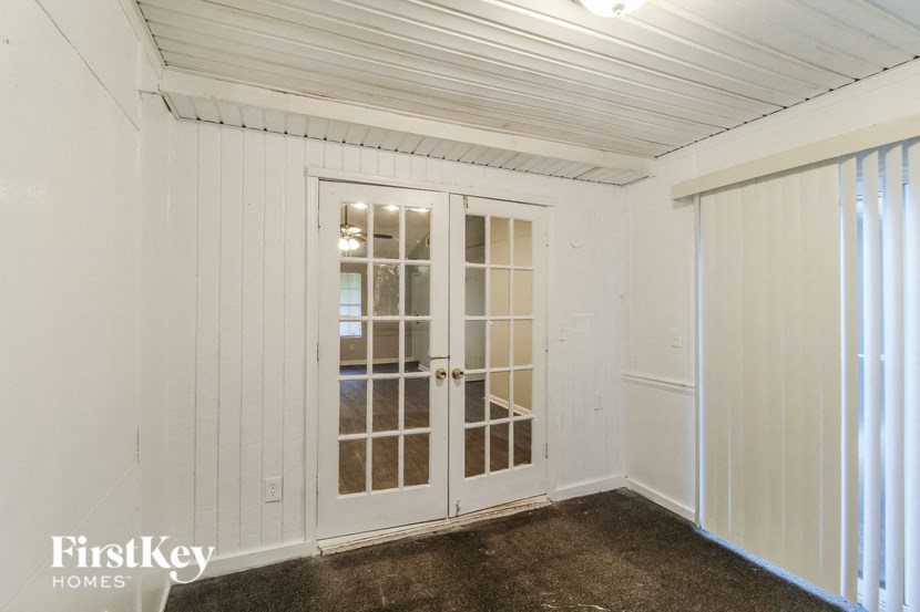 the interior of a shed with white walls and doors