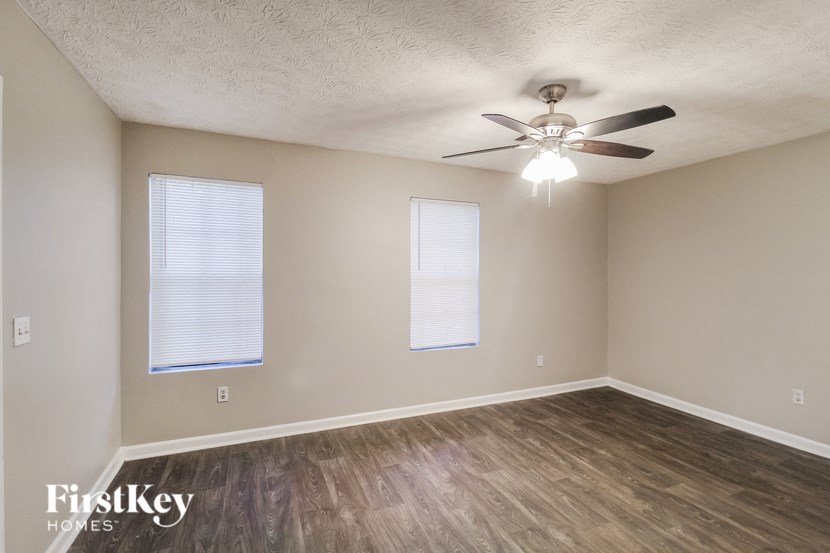 a living room with a ceiling fan and wood floors