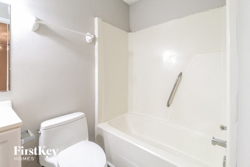 a bathroom with a tub and a toilet and a sink