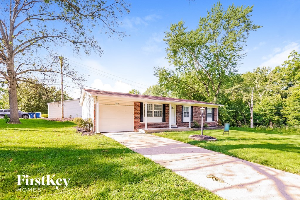 A house with a white garage door is for sale by FirstKey Homes.