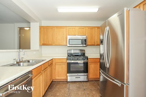 A kitchen with wooden cabinets and stainless steel appliances.