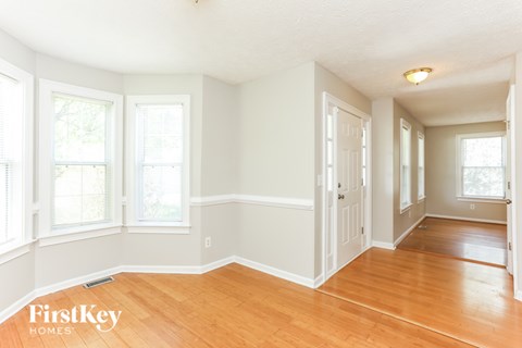 A room with wooden floors and white walls.