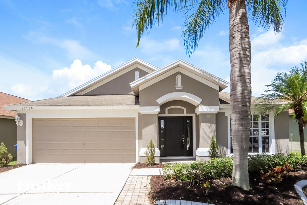 a house with a palm tree in front of it