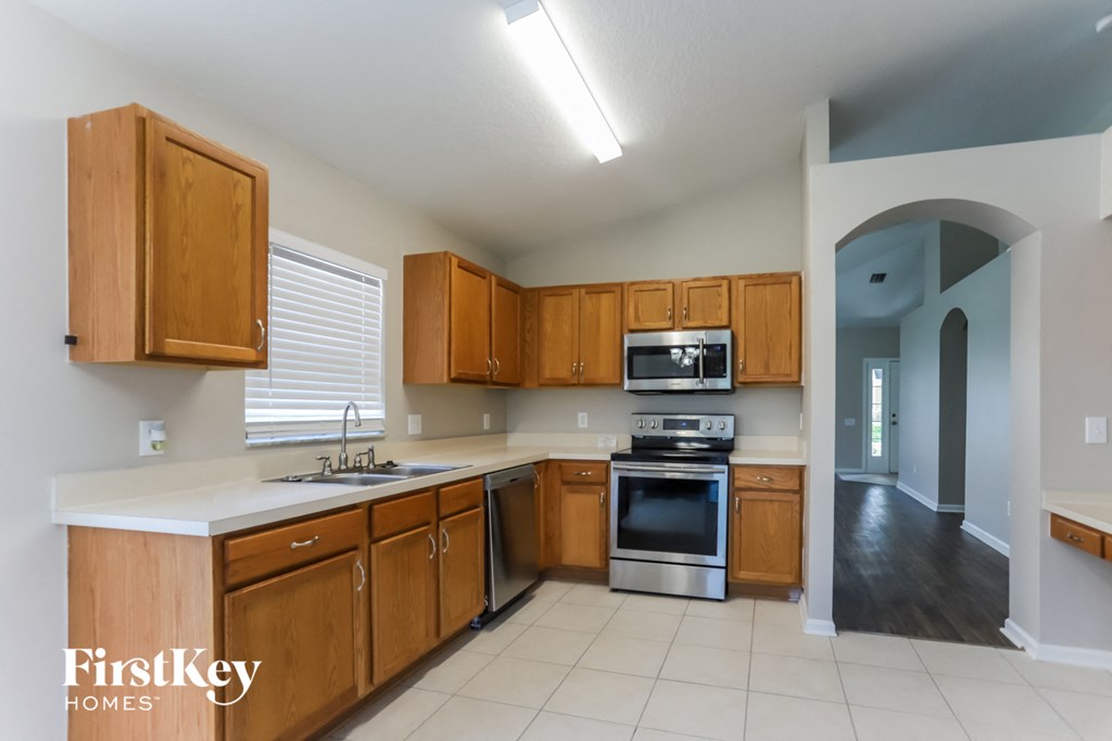 a kitchen with wooden cabinets and a white counter top