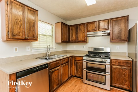 A kitchen with wooden cabinets and stainless steel appliances.