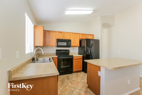 a kitchen with black appliances and wooden cabinets