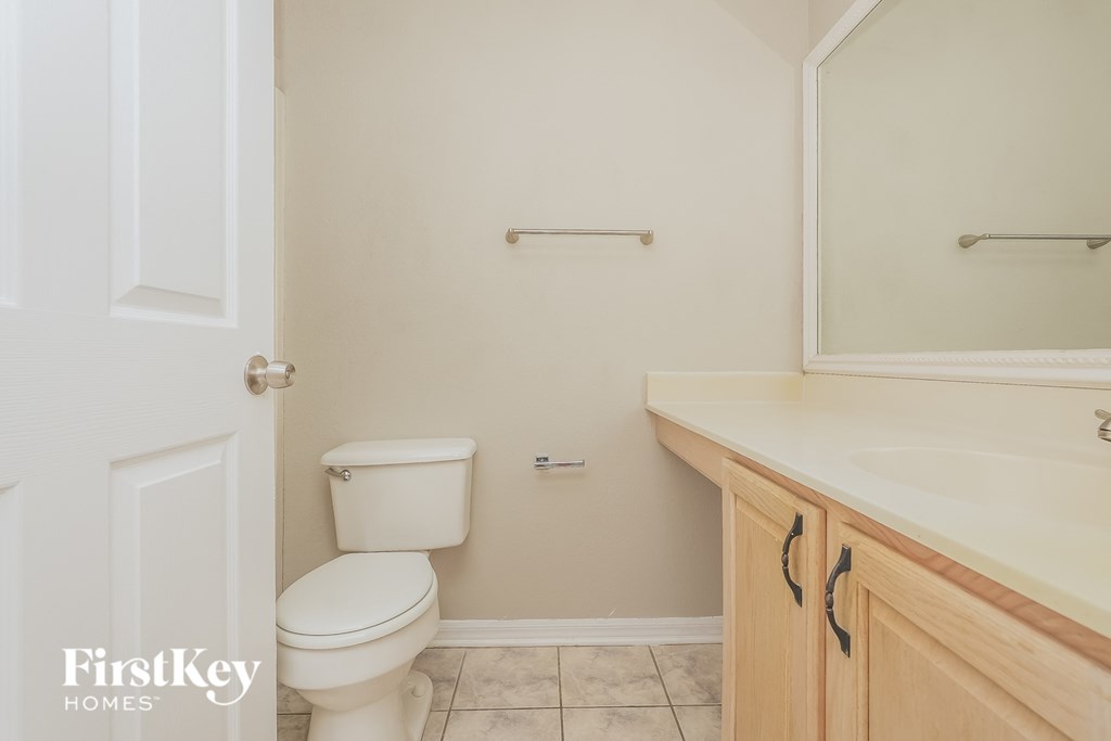 a bathroom with a toilet and a sink and a mirror
