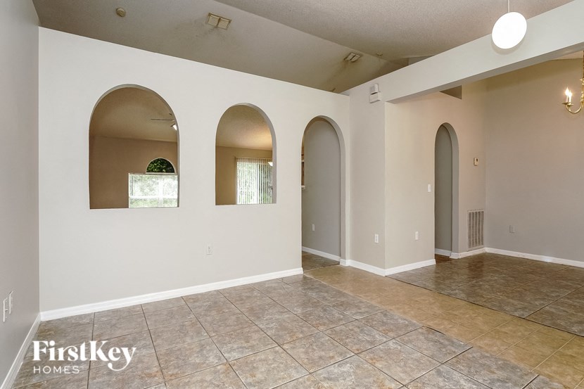 the living room and dining room with arched doorways