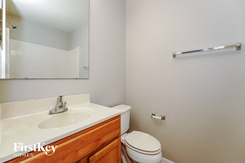 a bathroom with a toilet and a sink and a mirror