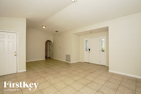 the living room and dining room are spacious with tile floors and white walls