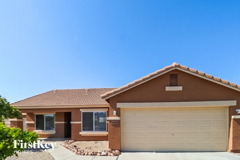 A house with a brown roof and a white garage door.