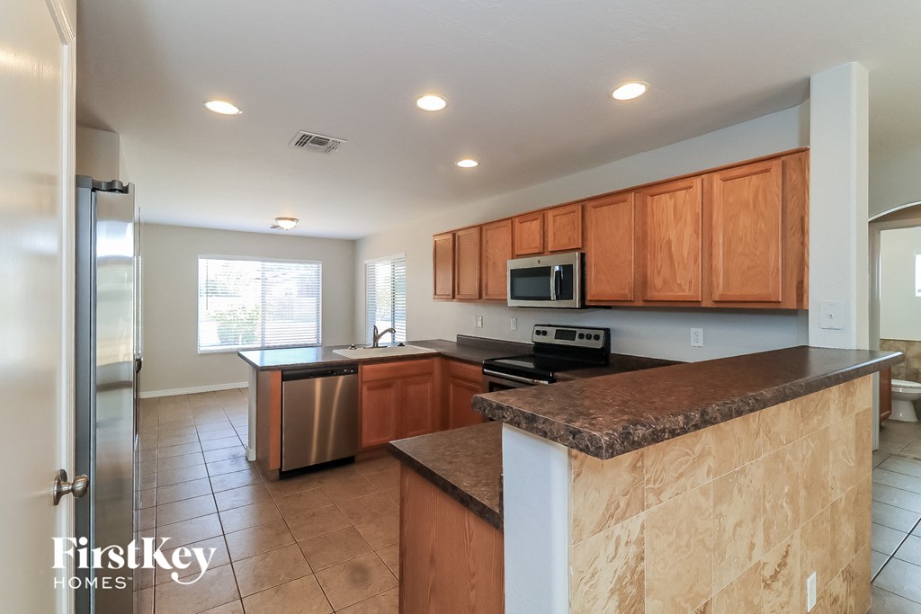 A kitchen with wooden cabinets and a granite countertop.